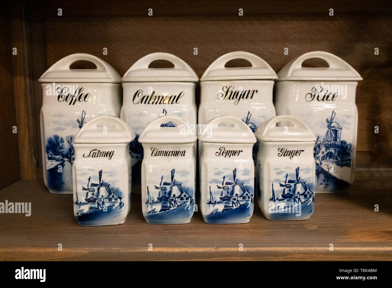 Kitchen shelf with china boxes for coffee, salt, pepper, nutmeg