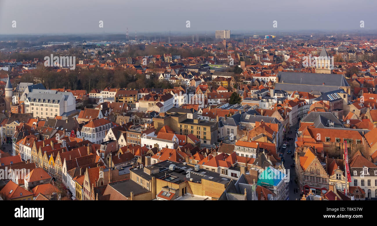 Fantastic Bruges city skyline with red tiled roofs and St. James's Church (Sint-Jakobskerk) in sunny winter day. View to Bruges medieval cityscape fro Stock Photo