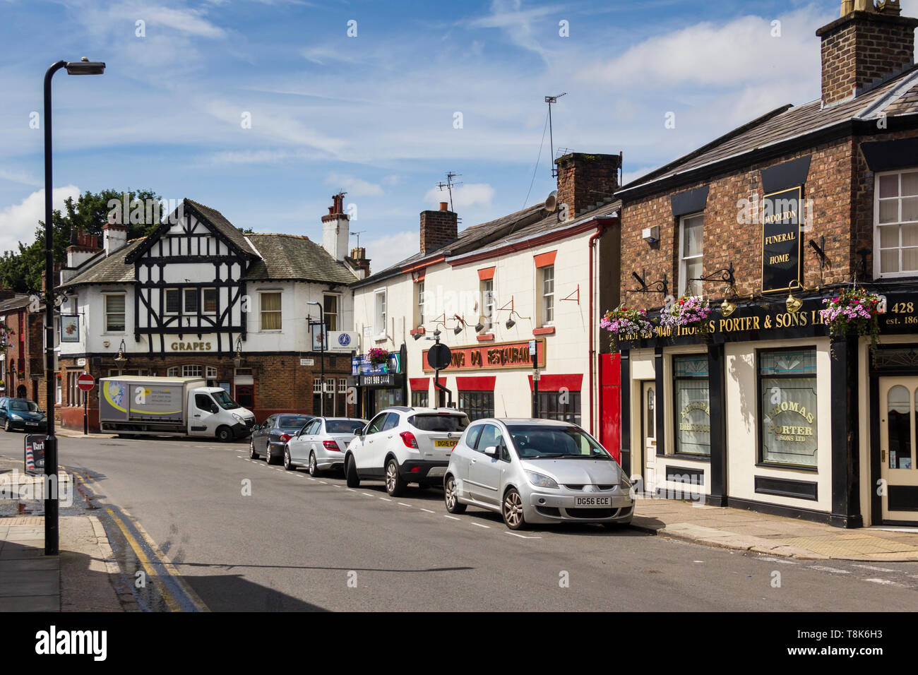 Allerton Road Woolton Liverpool, featuring The Grapes public house, Thomas Porter and Sons Ltd funeral directors and the King Do Chinese restaurant. Stock Photo