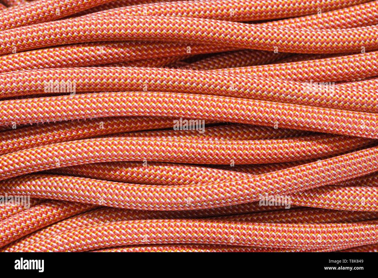 background of strands of coiled orange climbing rope Stock Photo