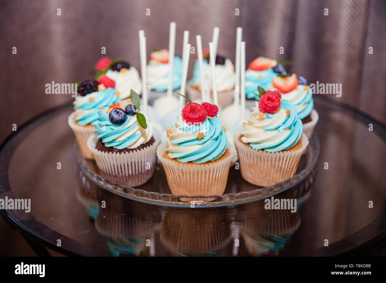 Delicious cupcakes with berries.Colorful cupcakes with buttercream and ...