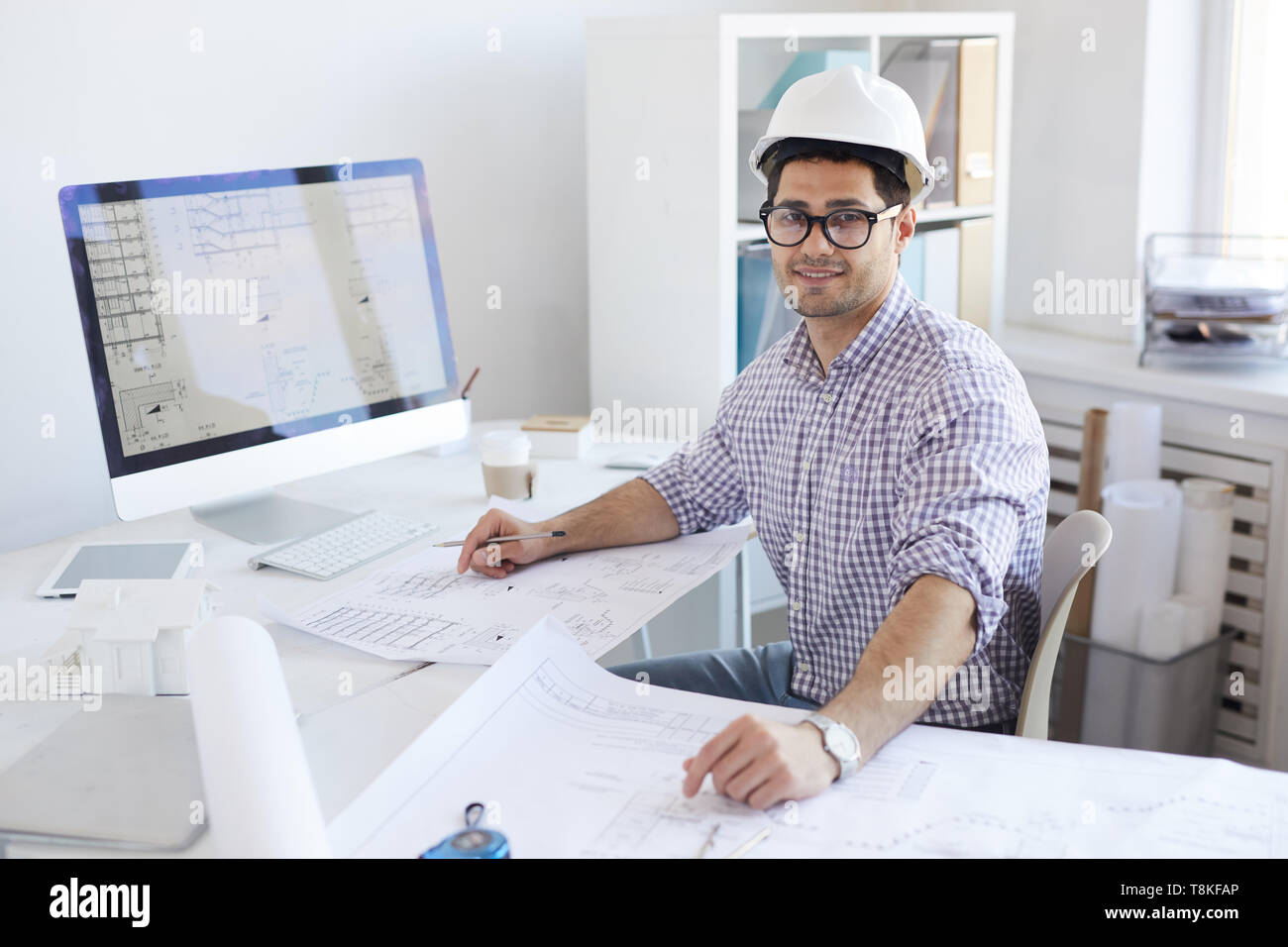 Smiling Engineer Posing at Workplace Stock Photo