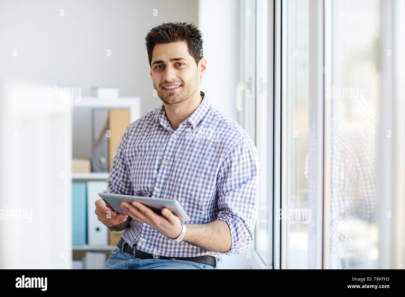 Middle-Eastern Man Holding Tablet Stock Photo