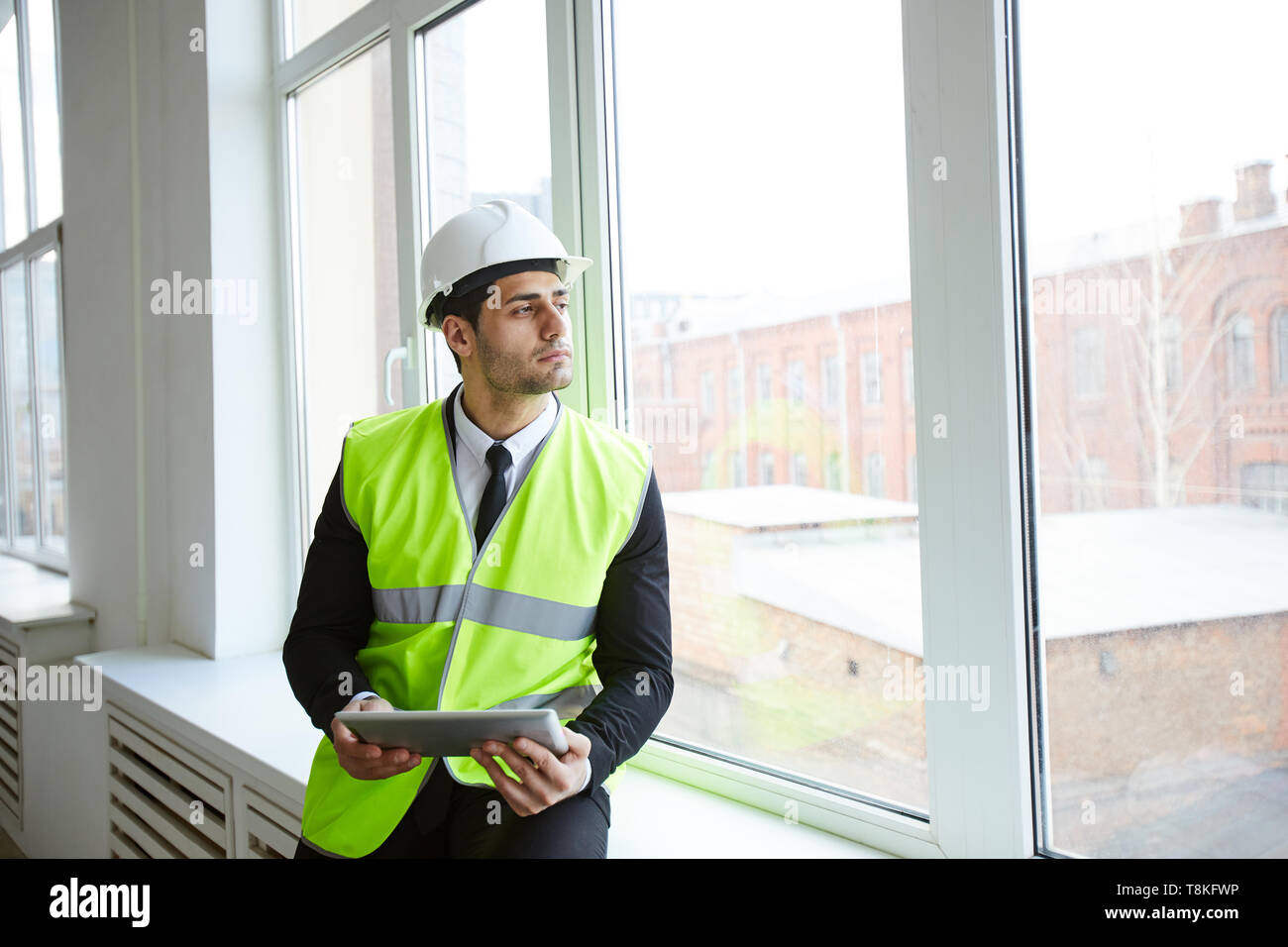 Pensive Businessman on Construction Site Stock Photo