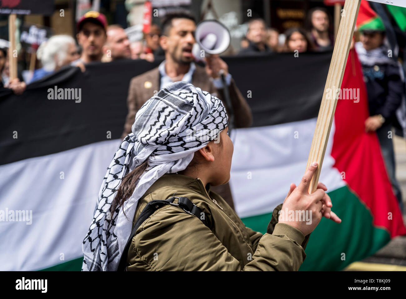 National Demonstration for Palestine, Nine year old Palestinian girl carrying a banner, London, UK 11/05/2019 Stock Photo