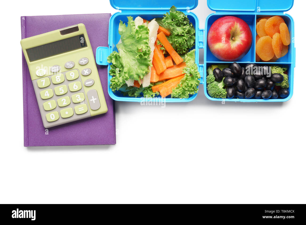 Food for schoolchild in lunch boxes and calculator on white background ...