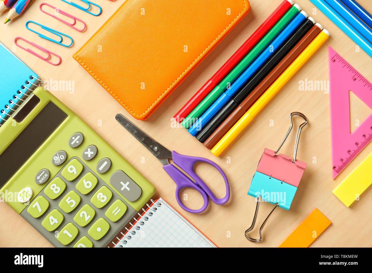 Composition with different school stationery and calculator on wooden background Stock Photo