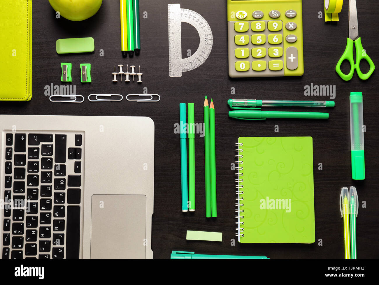 Set of school stationery with laptop on dark background Stock Photo - Alamy