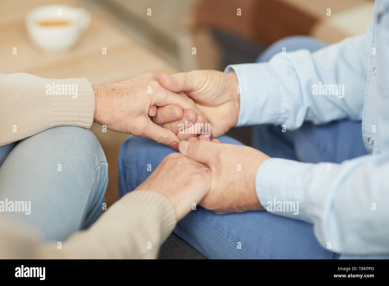 Caring Couple Holding Hands Stock Photo