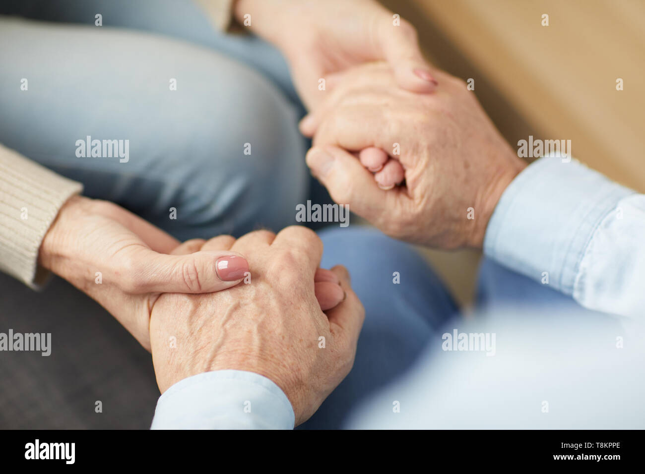 Caring Senior Couple Holding Hands Stock Photo