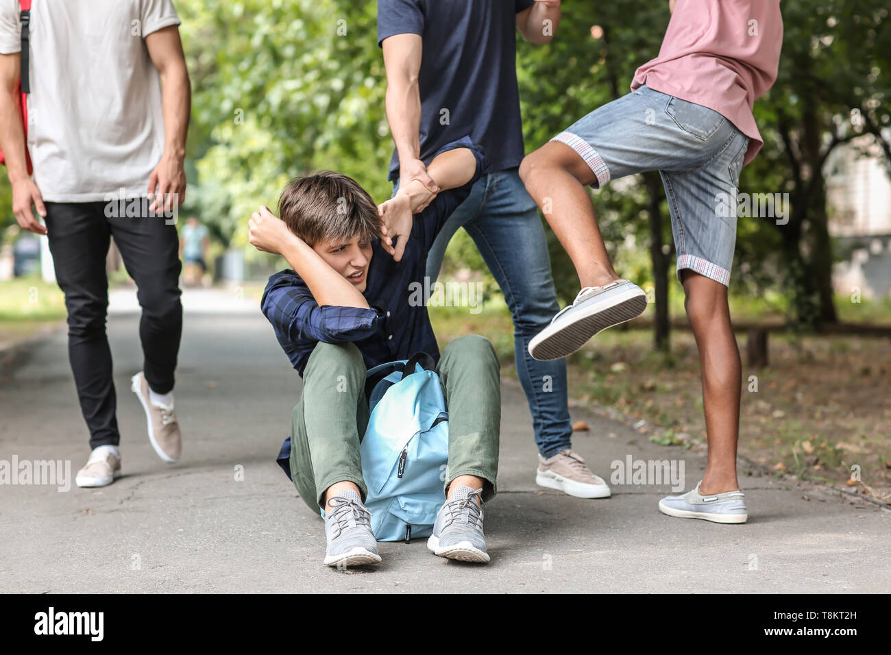 Aggressive teenagers bullying boy outdoors Stock Photo Alamy