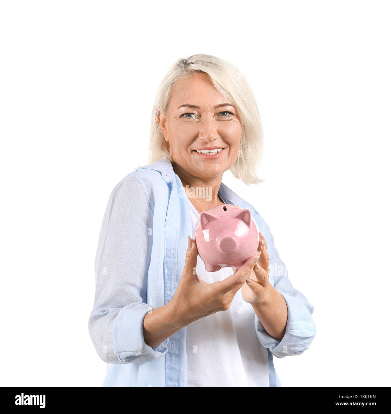 Mature woman with piggy bank on white background Stock Photo - Alamy