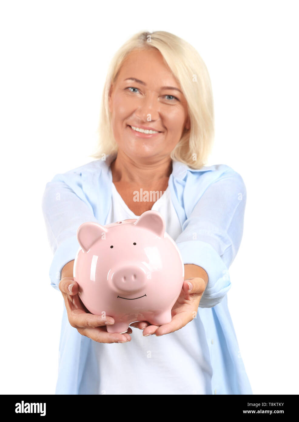 Mature woman with piggy bank on white background Stock Photo - Alamy