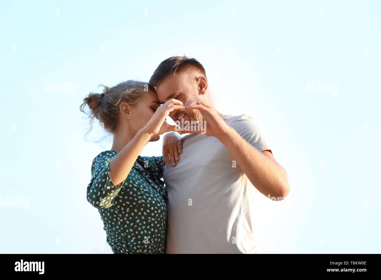 Cute young couple making heart with their hands outdoors Stock Photo ...