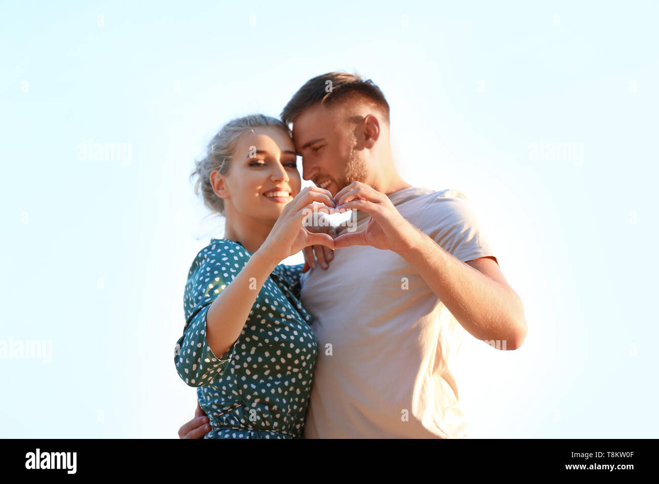 Cute young couple making heart with their hands outdoors Stock Photo ...