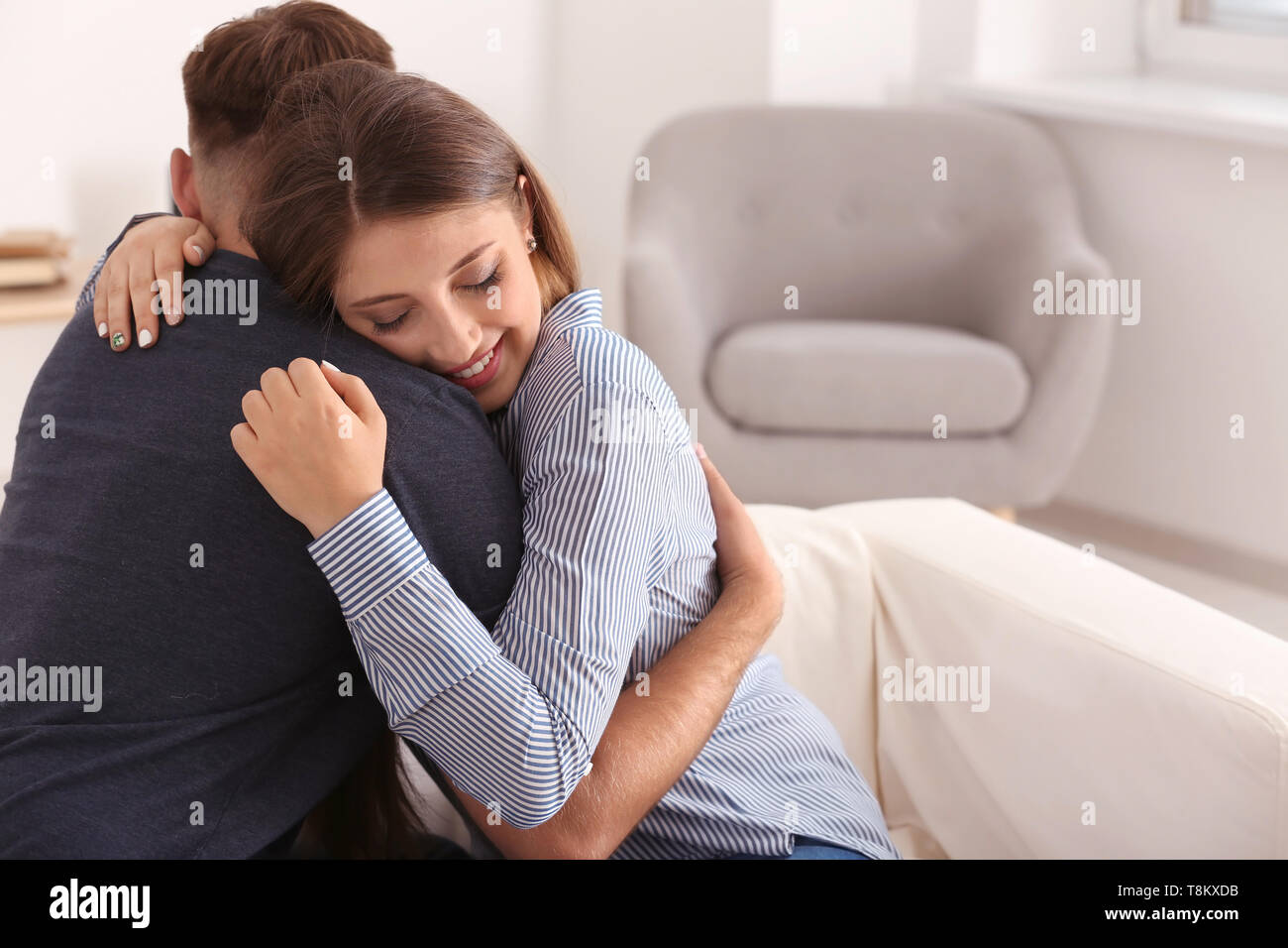 Loving woman hugging beloved hi-res stock photography and images - Alamy