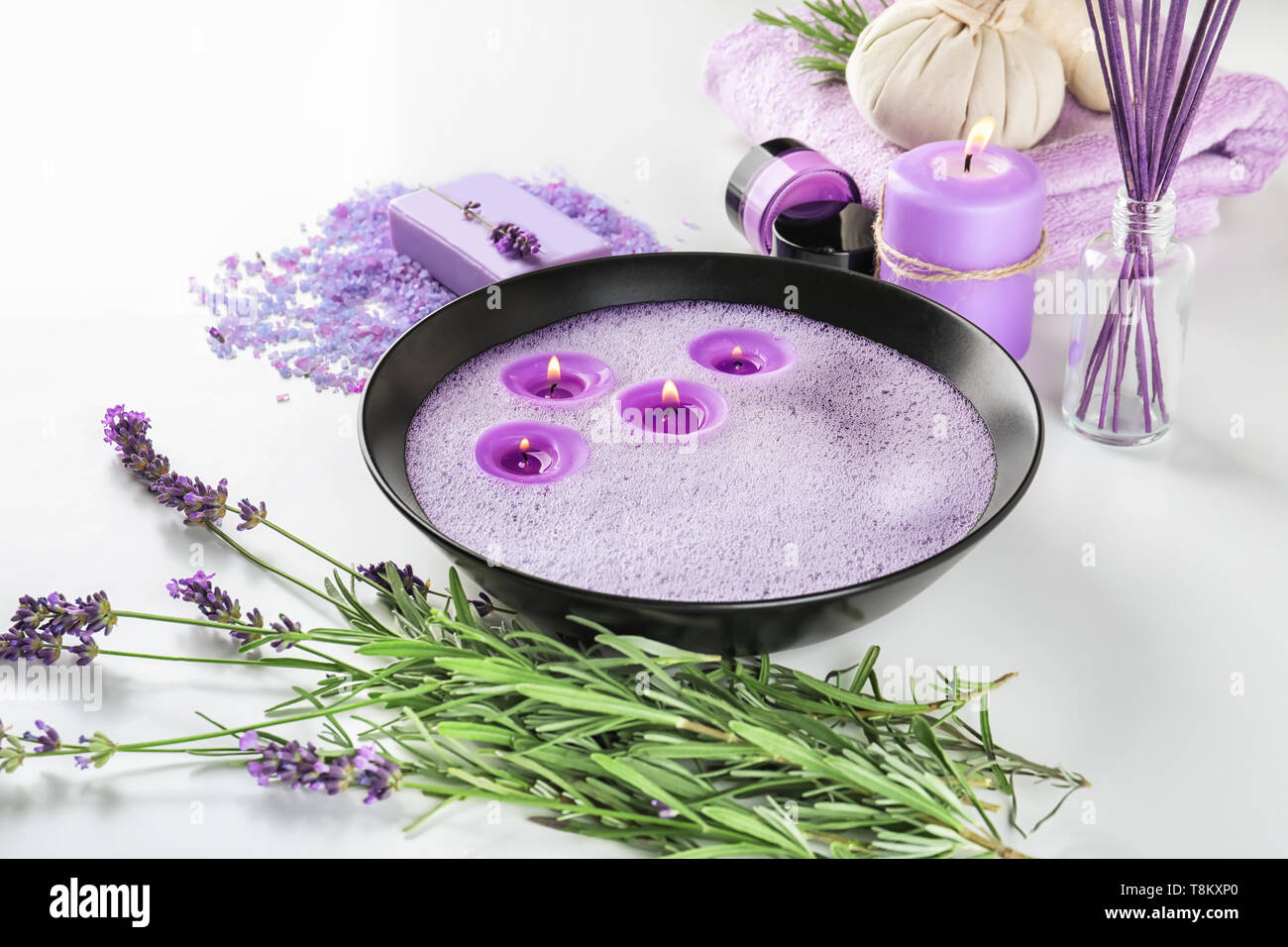 Bowl with candles and bath products on white background Stock Photo Alamy