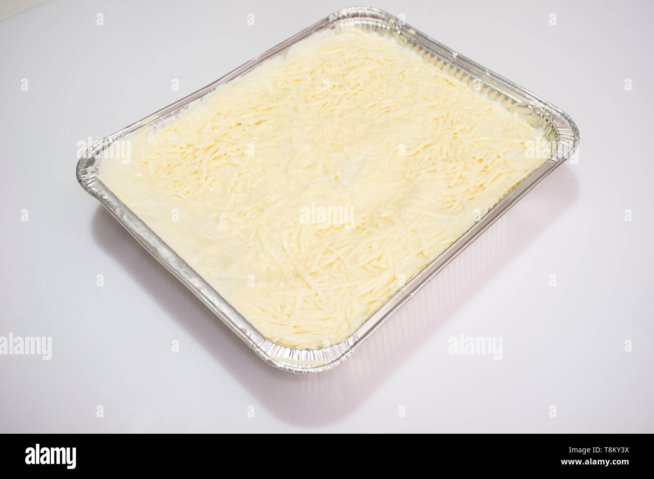 Precooked cold lasagne foil tray. Isolated over white Stock Photo Alamy