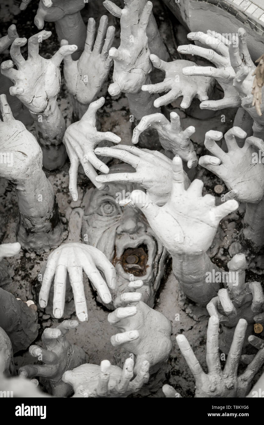 Ghostly arts from the afterlife near the bridge towards the entrance of the Wat Rong Khun, Thailand Stock Photo