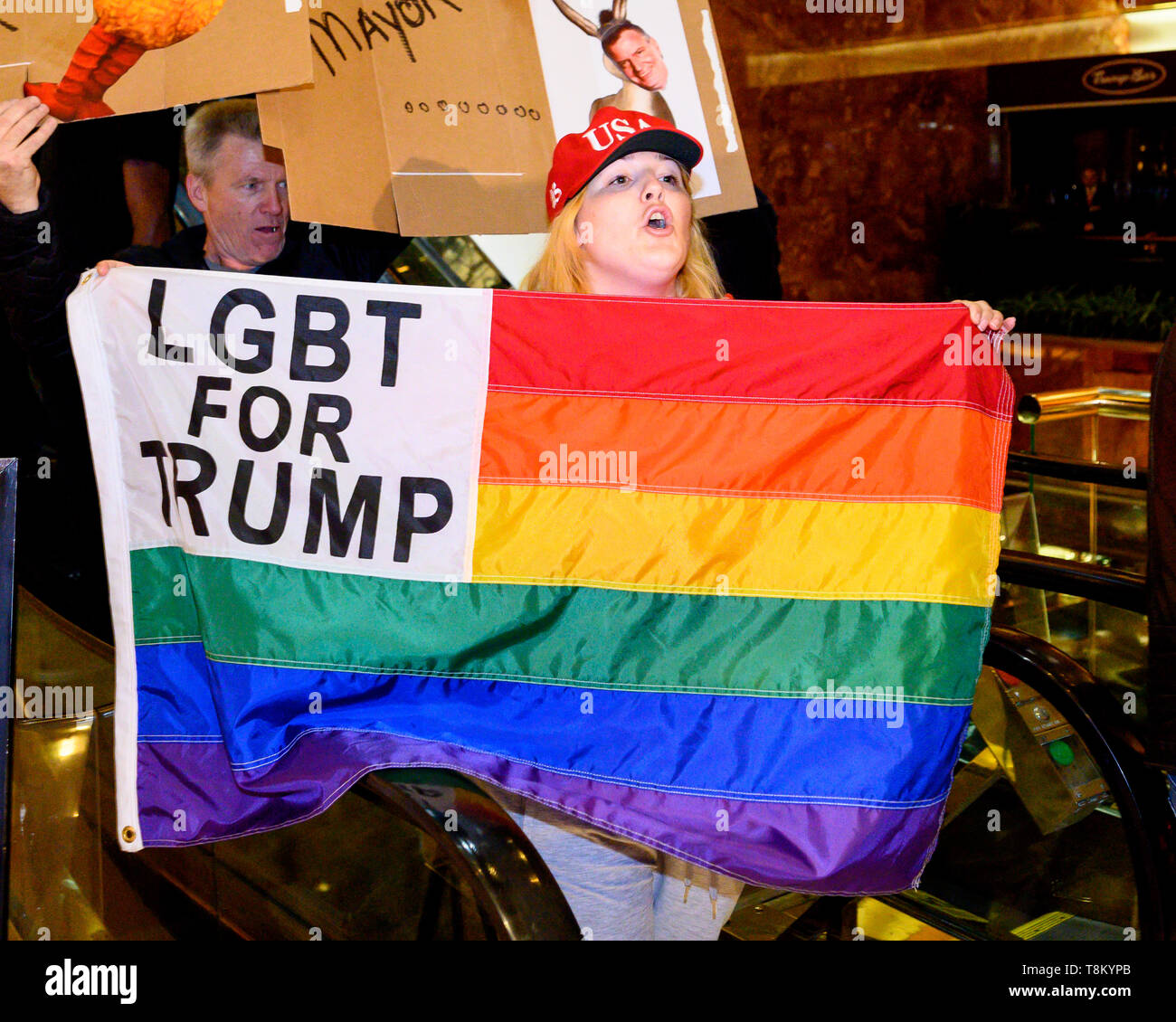 A Protester seen holding a LGBT for Trump flag during the Green New Deal rally with New York City Mayor Bill de Blasio (D) held at the public plaza in Trump Tower in New York City, New York. Stock Photo