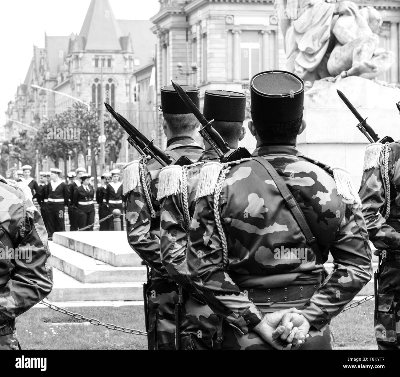 Rear view of soldiers at ceremony to mark Western allies World War Two victory Armistice in Europe marking the 72nd anniversary of victory over Nazi Germany in 1945 black and white. Stock Photo