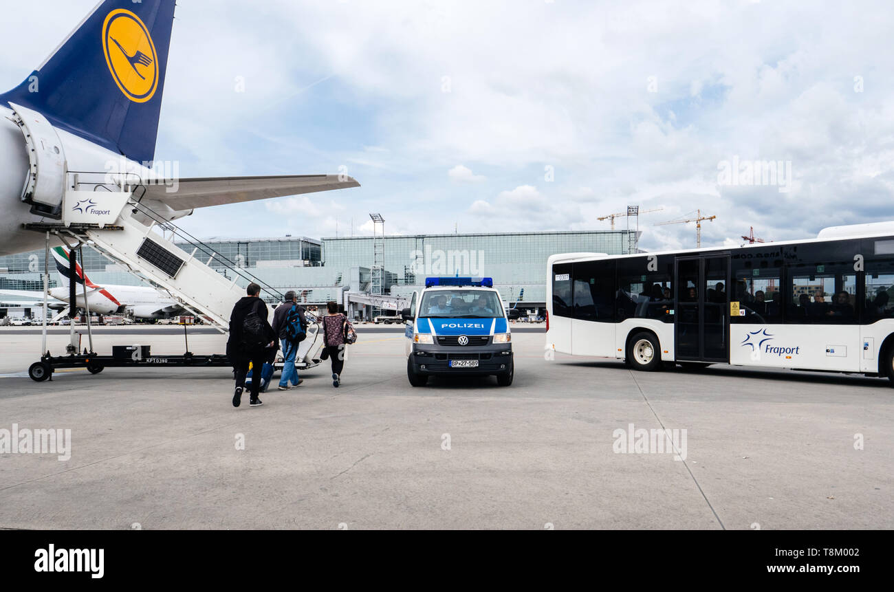 Frankfurt, Germany - Apr 29, 2019: Airbus A321-231 D-AISO on tarmac with Polizei police van and Fraport bus with passengers preparing for departure Stock Photo