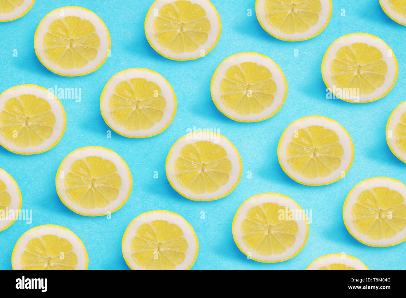 Lemon pattern on a bright blue background. Flat lay summer concept. Stock Photo