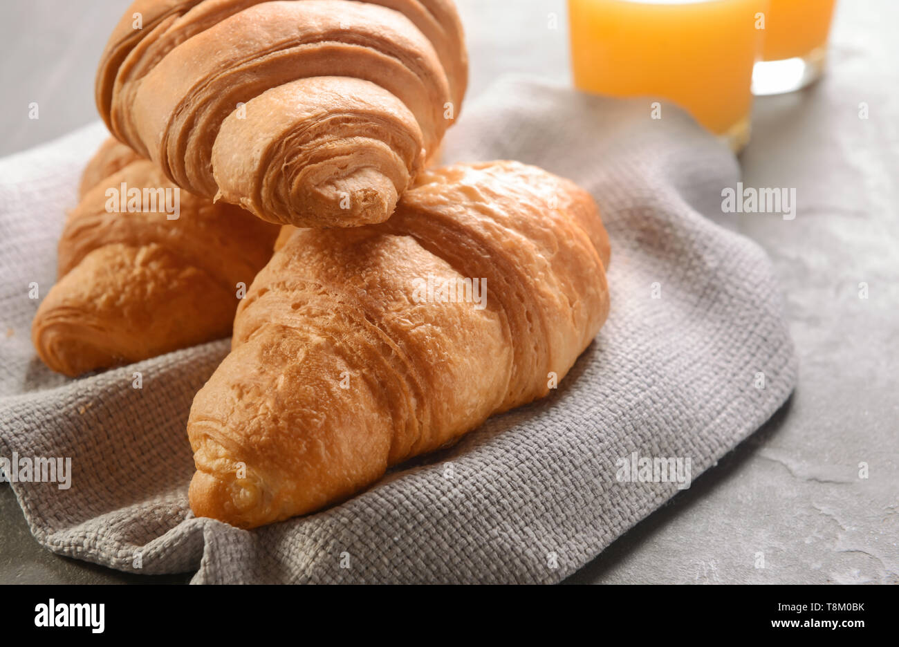 Tasty croissants on grey table Stock Photo