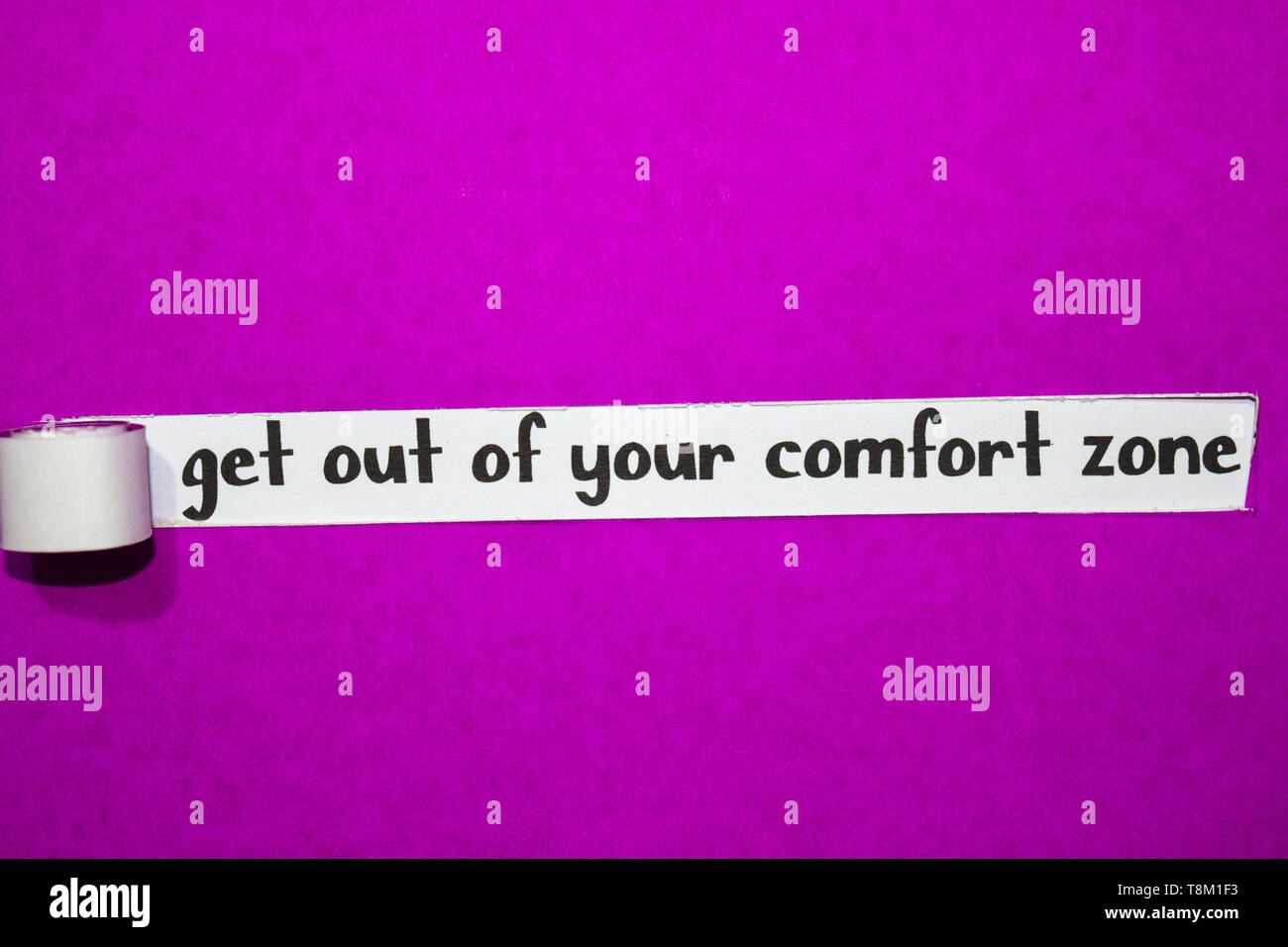 get out of your comfort zone text, Inspiration, Motivation and business concept on purple torn paper Stock Photo