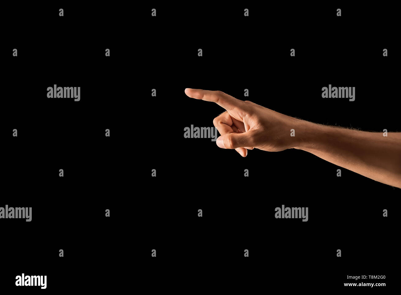 Young man using virtual screen on dark background Stock Photo