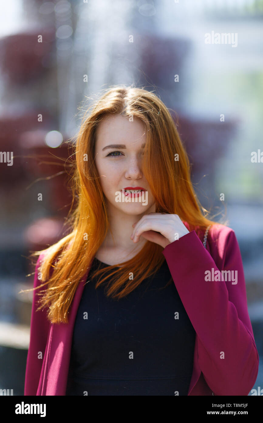 Happy girl with red hair walking in the Park Stock Photo - Alamy