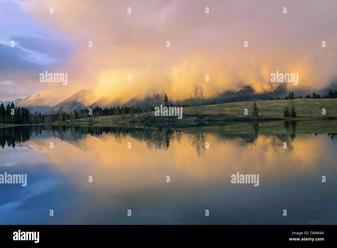 Springtime Mountain Landscape and Dramatic Sunset Colors. Quarry Lake, City of Canmore, Alberta Foothills, Canadian Rockies, Banff National Park Stock Photo