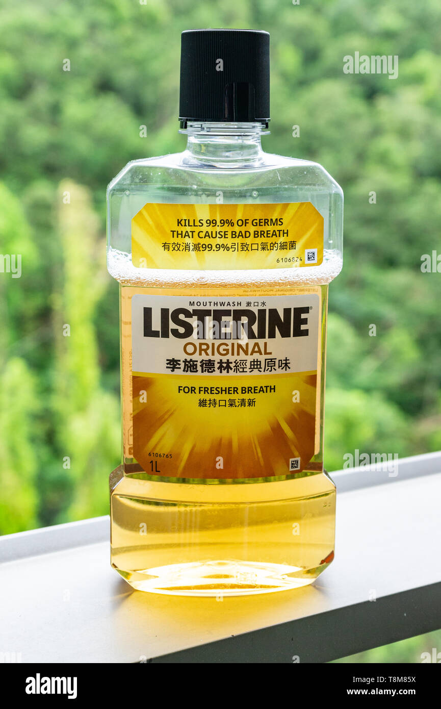 Photo of Listerine bottle, Chinese language label, partly full against