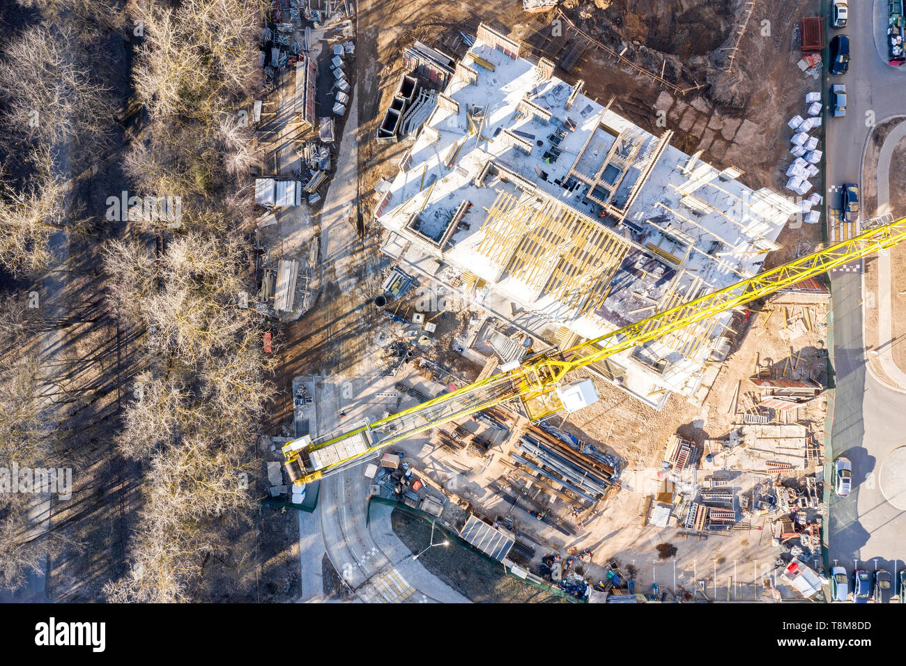 aerial top view of urban construction area with high yellow tower ...