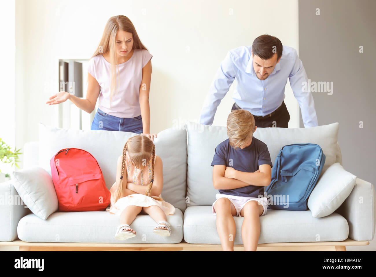 Displeased parents and their children after meeting with headmaster at ...