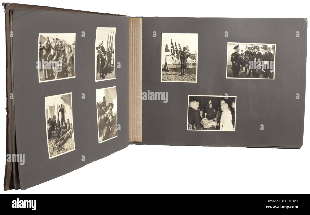 A photo album of the Reich Party Rally of Honour 1936 Large-size album with cardboard cover, the latter inscribed 'Parteitag 1936' and 'Property of: ...'. A unique, special album, all 145 photos (9 x 12 cm) were taken by Heinrich Hoffmann. The pictures were partially also used for the stereoscopic album (tr.) 'Reich Party Rally of Honour 1936'. They are of high quality, glued into the album and partially captioned. They show preparations for the parade, in an SS tent camp, Reichsführer SS H. Himmler visiting members of the Leibstandarte Adolf Hitler. Rudolf Heß, Gauleiter S, Editorial-Use-Only Stock Photo