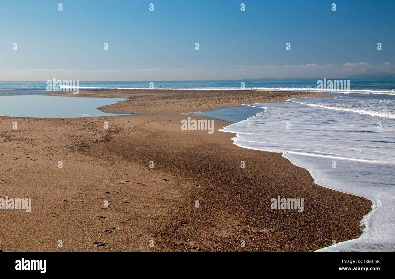 Small sandbar where the Pacific ocean and the Santa Clara river meet at Surfers Knoll beach in Ventura California United States Stock Photo