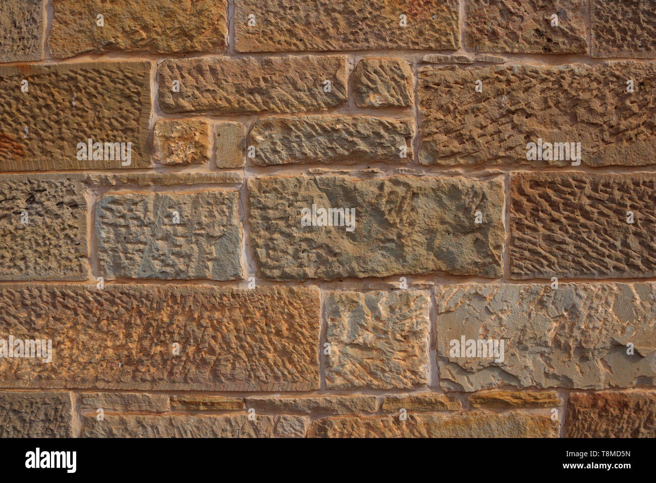 Colonial era sandstone block wall in Tasmania Australia  made by convict labour showing stipples and chisel marks background with copy space Stock Photo