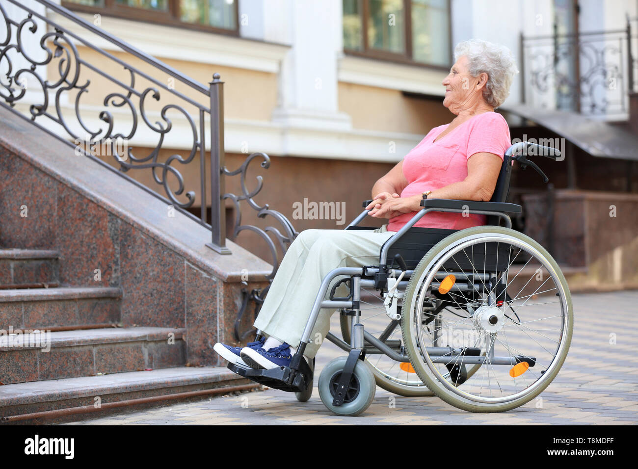 Woman wheelchair stairs hi-res stock photography and images - Alamy