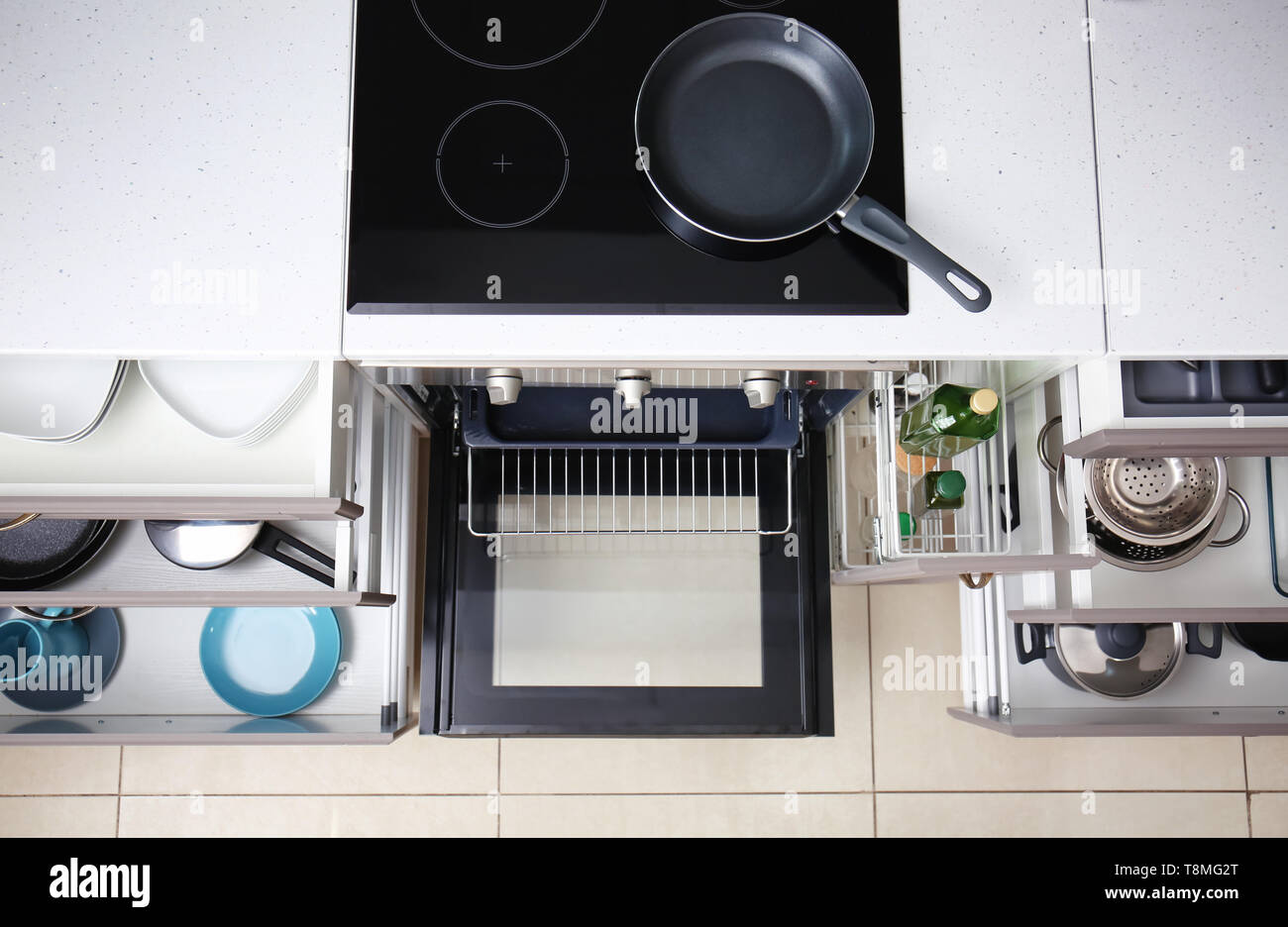 Set of clean kitchenware in drawers Stock Photo - Alamy