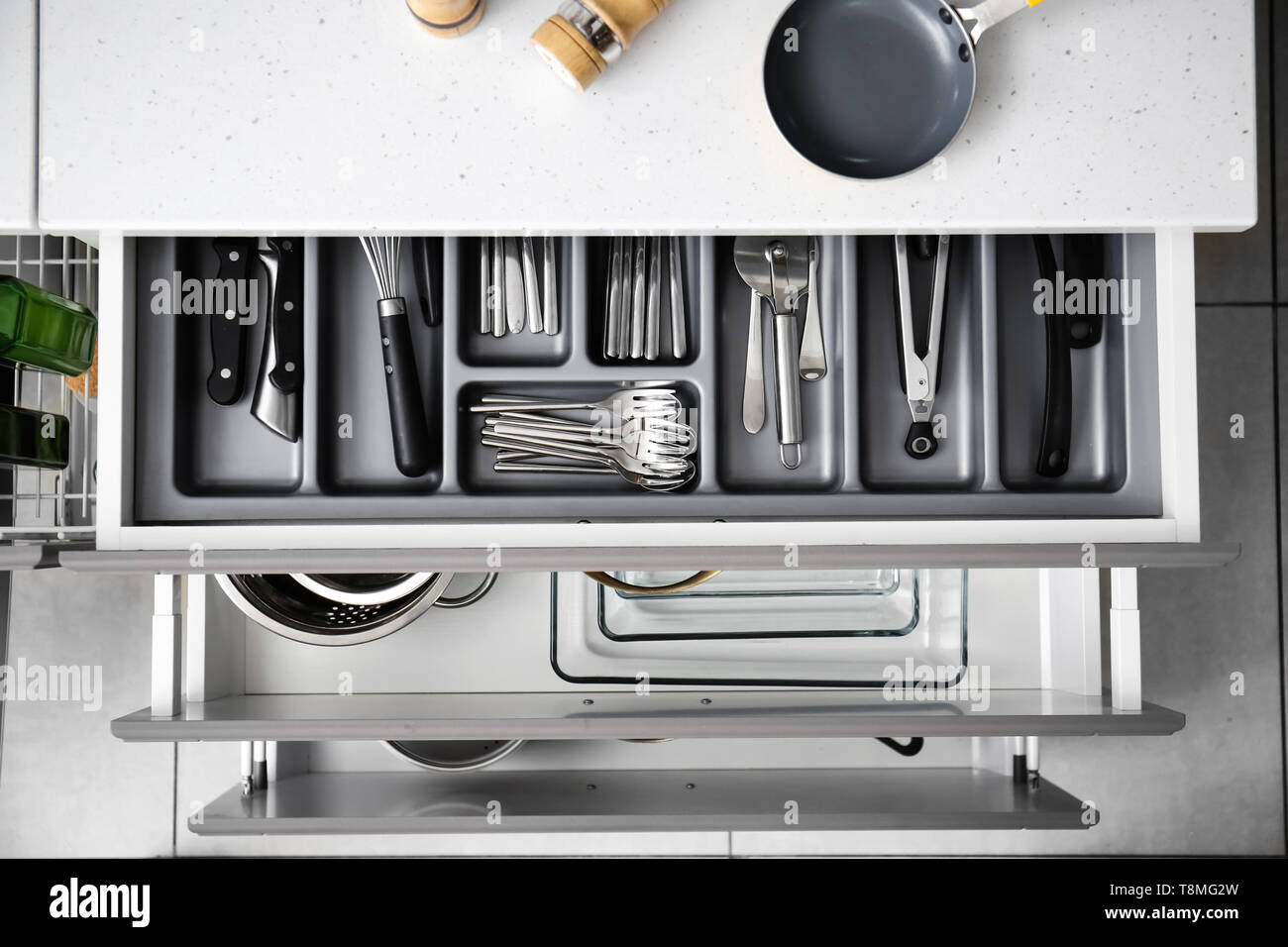 Set of clean kitchenware and utensils in drawers Stock Photo - Alamy