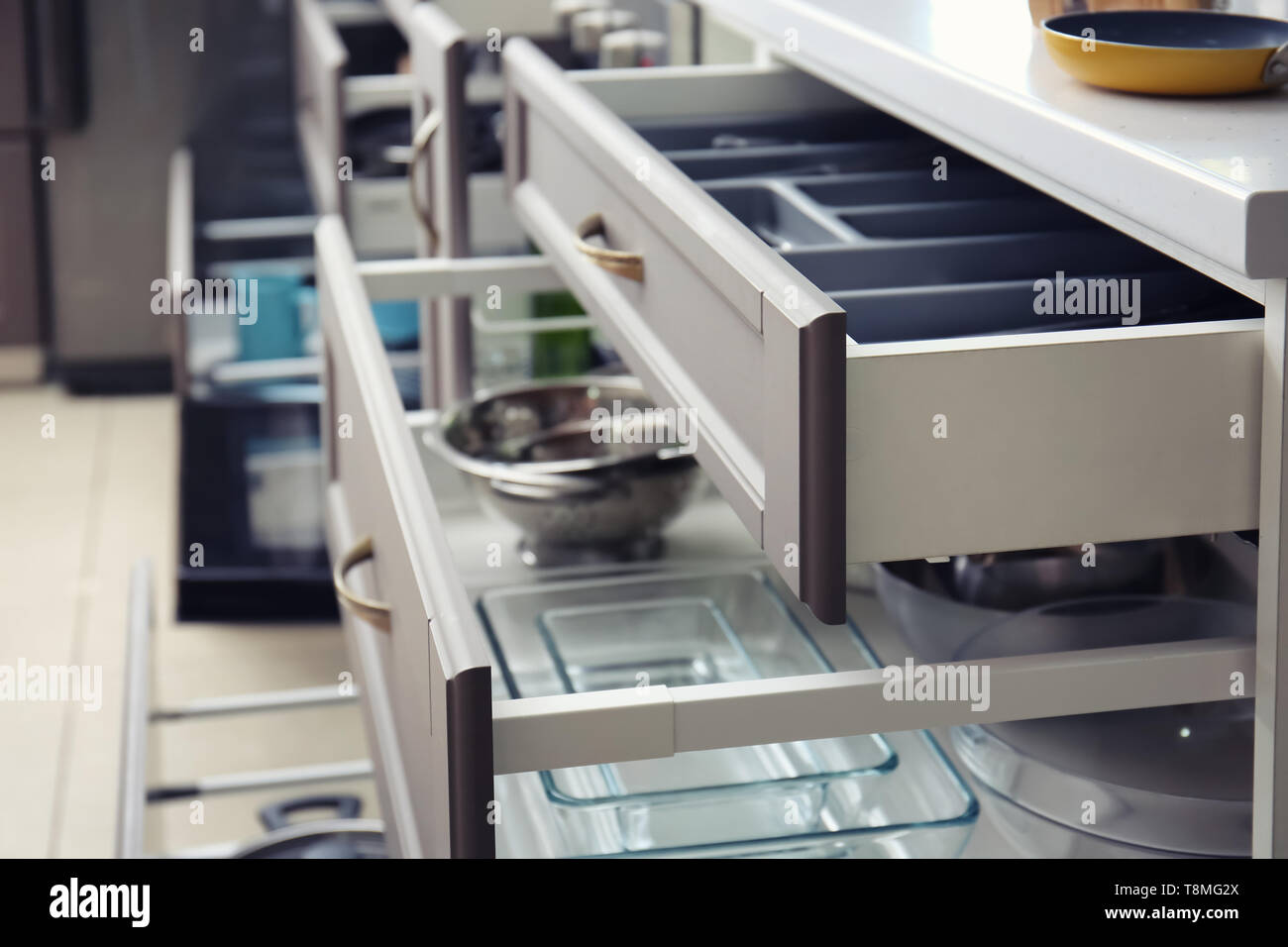 Set of clean kitchenware in drawers Stock Photo - Alamy