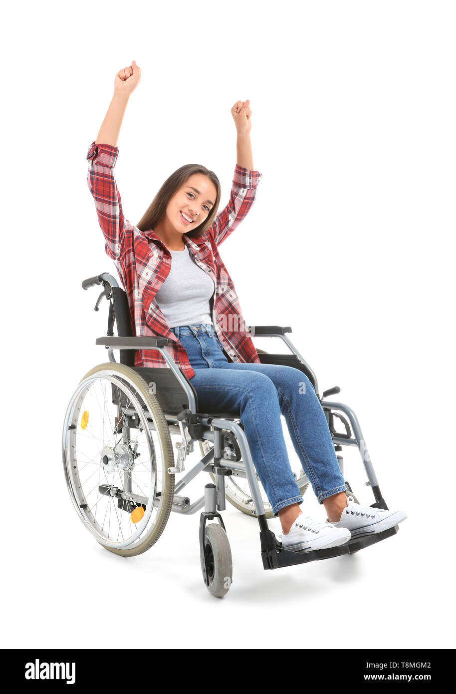 Happy young woman sitting in wheelchair on white background Stock Photo ...