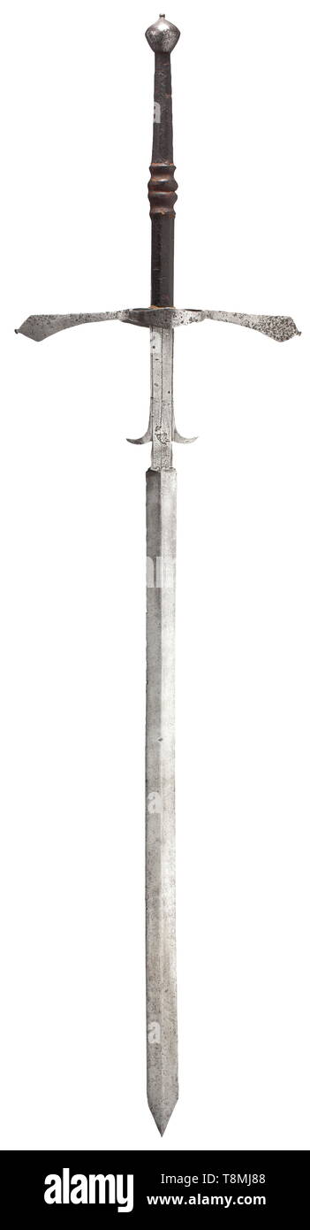 A South German Two Hand Sword Circa 1580 Broad Double Edged Blade With A Medial Ridge On Each Side Long Ricasso With Decorative Lines And Lugs Separated On The Sides Extended Quillons Conically Widening A South German Two Hand Sword Circa 1580 Broad Double Edged Blade With A Medial Ridge On Each Side Long Ricasso With Decorative Lines And Lugs Separated On The Sides Extended Quillons Conically Widening