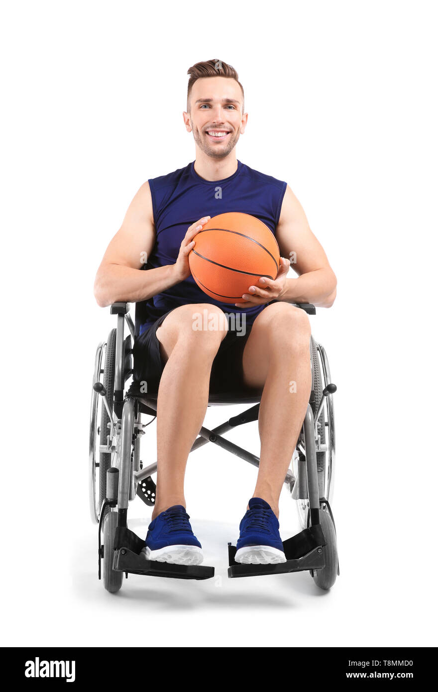 Young basketball player sitting in wheelchair on white background Stock Photo