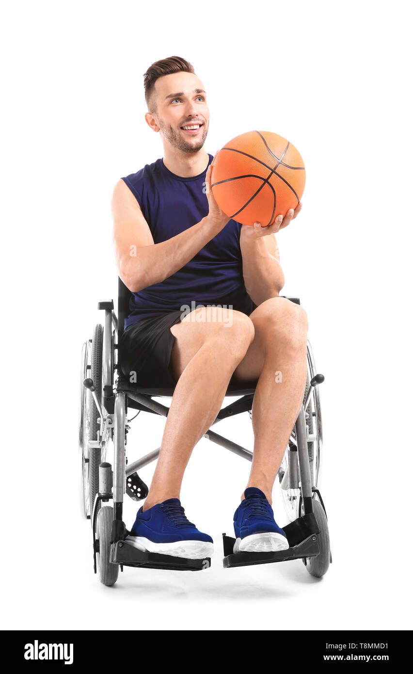 Young basketball player sitting in wheelchair on white background Stock Photo