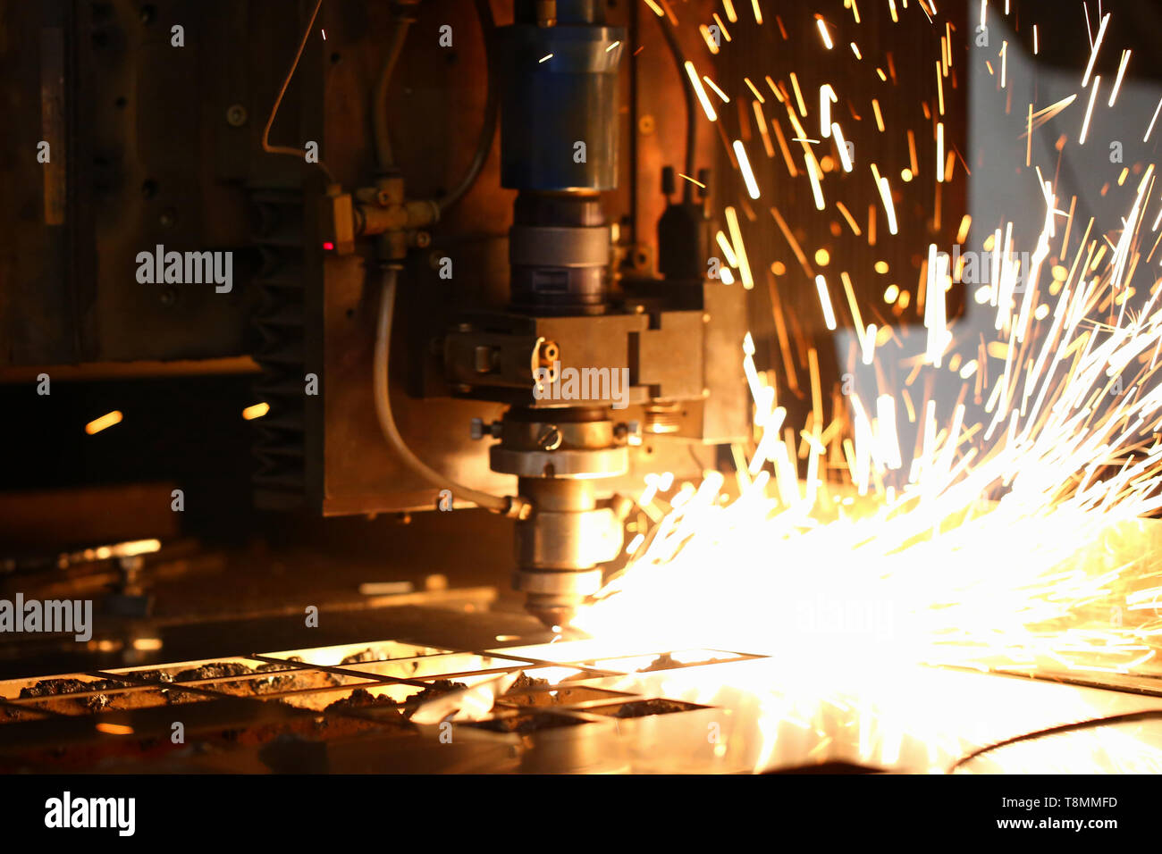 Sparks fly out machine head for metal processing Stock Photo