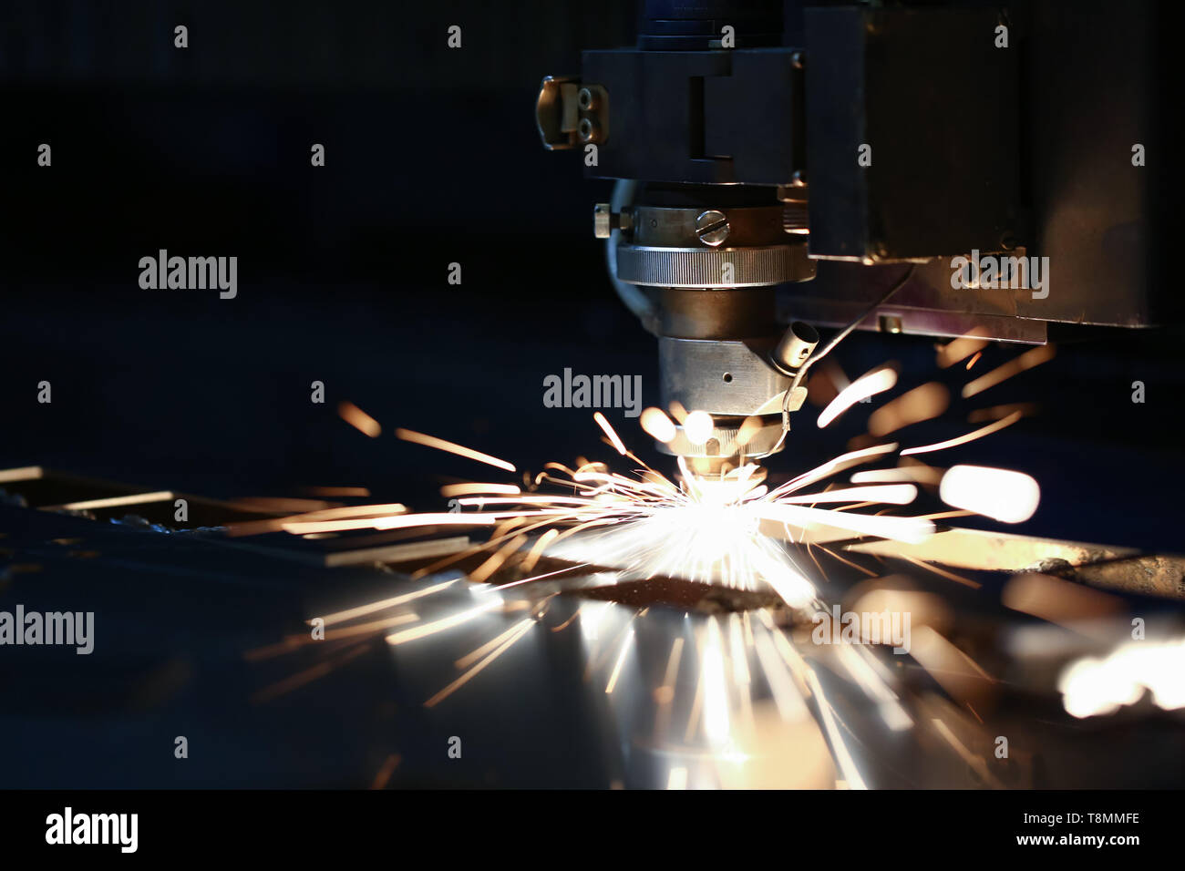 Sparks fly out machine head for metal processing Stock Photo