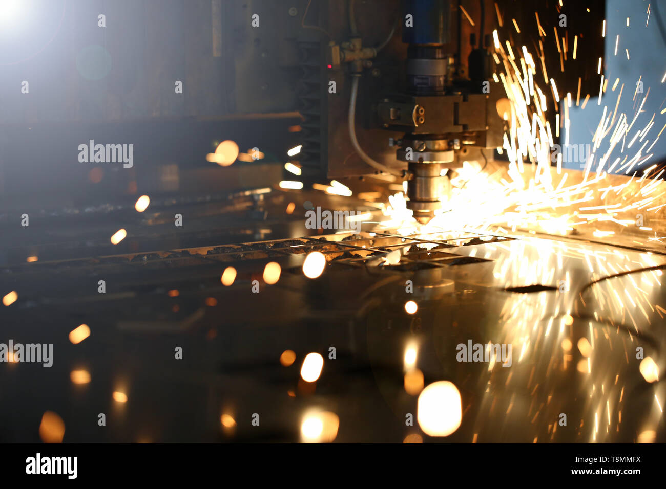 Sparks fly out machine head for metal processing Stock Photo