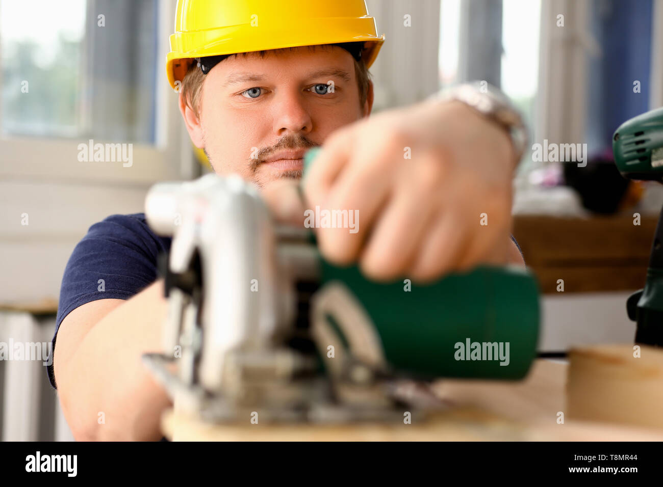 Worker using electric saw portrait manual job Stock Photo Alamy